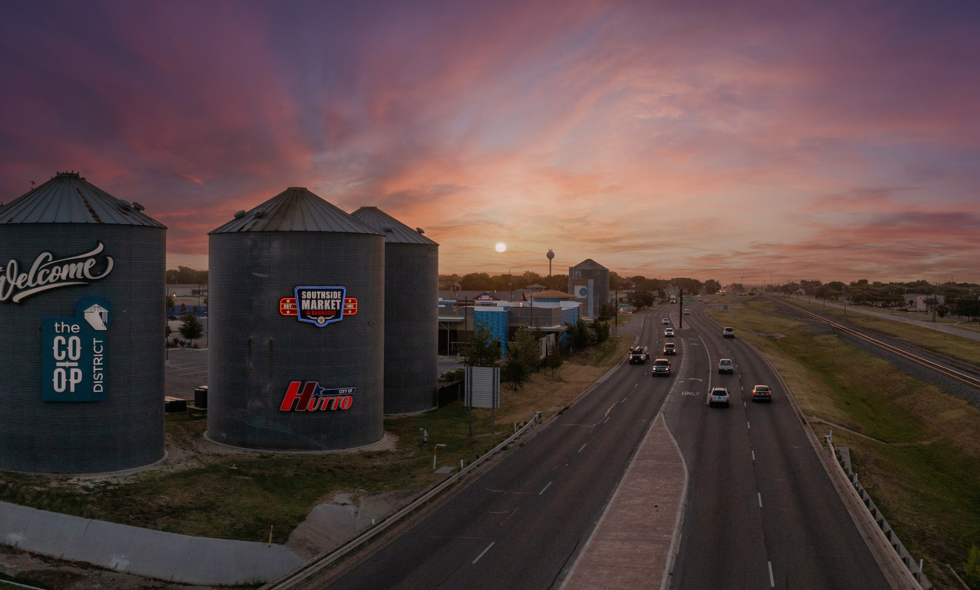Sunset photo of Hutto Silos and adjacent highway