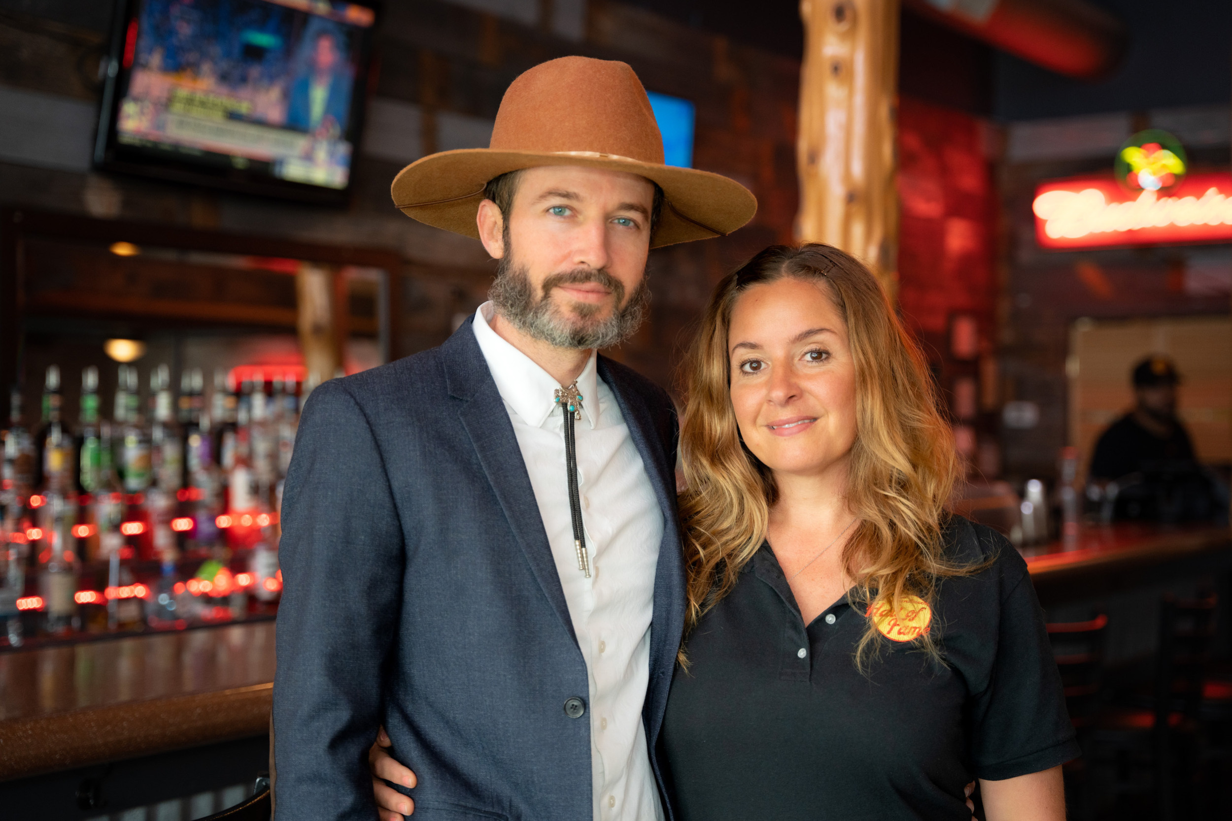 Photo of couple standing in front of a bar